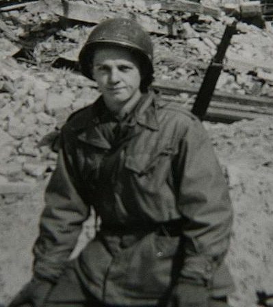 Technician 5th Grade T/5 Wayne Allen Stamm, 36771374 US Army. He was born on June 5, 1924 in McConnell, Illinois the son of Esther and Elmer Stamm. He graduated from Winslow High School in 1942. He entered the Army Air Corp in 1943, around the age of 19. After graduating from Air Gunner School where he trained to be a ball turret gunner on a B-24, he was transferred to the infantry. In February 1945 he entered Second Platoon in John Crews Squad, Company F, 253rd Infantry Regiment, 63rd Infantry Division. He fought in the Battle of Buchhof and Stine, and would have been one of the twenty-three uninjured men in platoon after Sgt. Crews earned his Medal of Honor. On April 17, 1945 T/5 Stamm was transferred to B Company, 253rd Infantry Regiment, 63rd Infantry Division. With B Company he took part in liberation one of the Landsberg Concentration Camp.He was Awarded the Combat Infantry Badge, the Bronze Star Medal, the Good Conduct Medal, The American Theater of operations, the European Theater of Operations Medal ETO with 2 battle star, the World War Two Victory Medal, the Army of Occupation Medal, Air Gunner Wings, and the Presidential Unit Citation. After the war he married Darlyne Schumacher, he earned a B.A. degree in Education from University of Dubuque. He also earned a Ph.D. in Educational Administration, he worked for the Department of Public Instruction where he remained until his retirement in 1988. He died on September 25, 2011, at the age of 87.